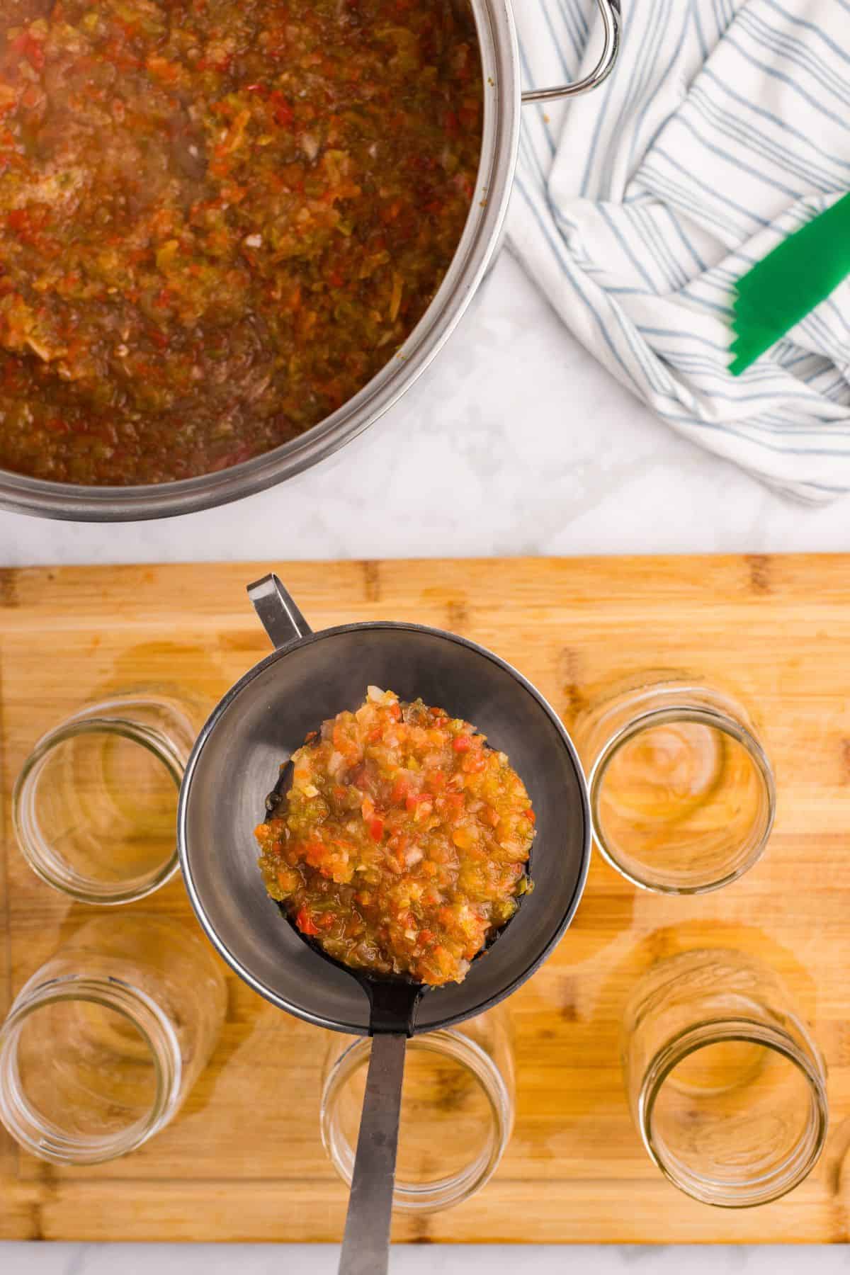 Filling jars with cooked relish mixture.