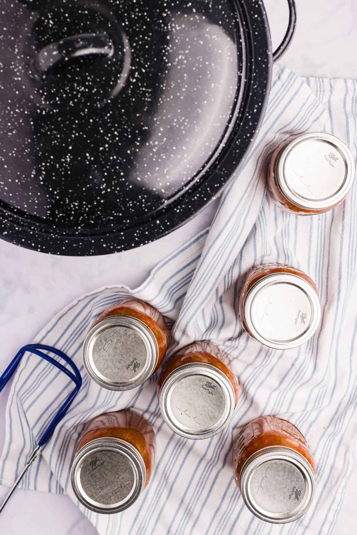 Processed jars cooling on a towel.