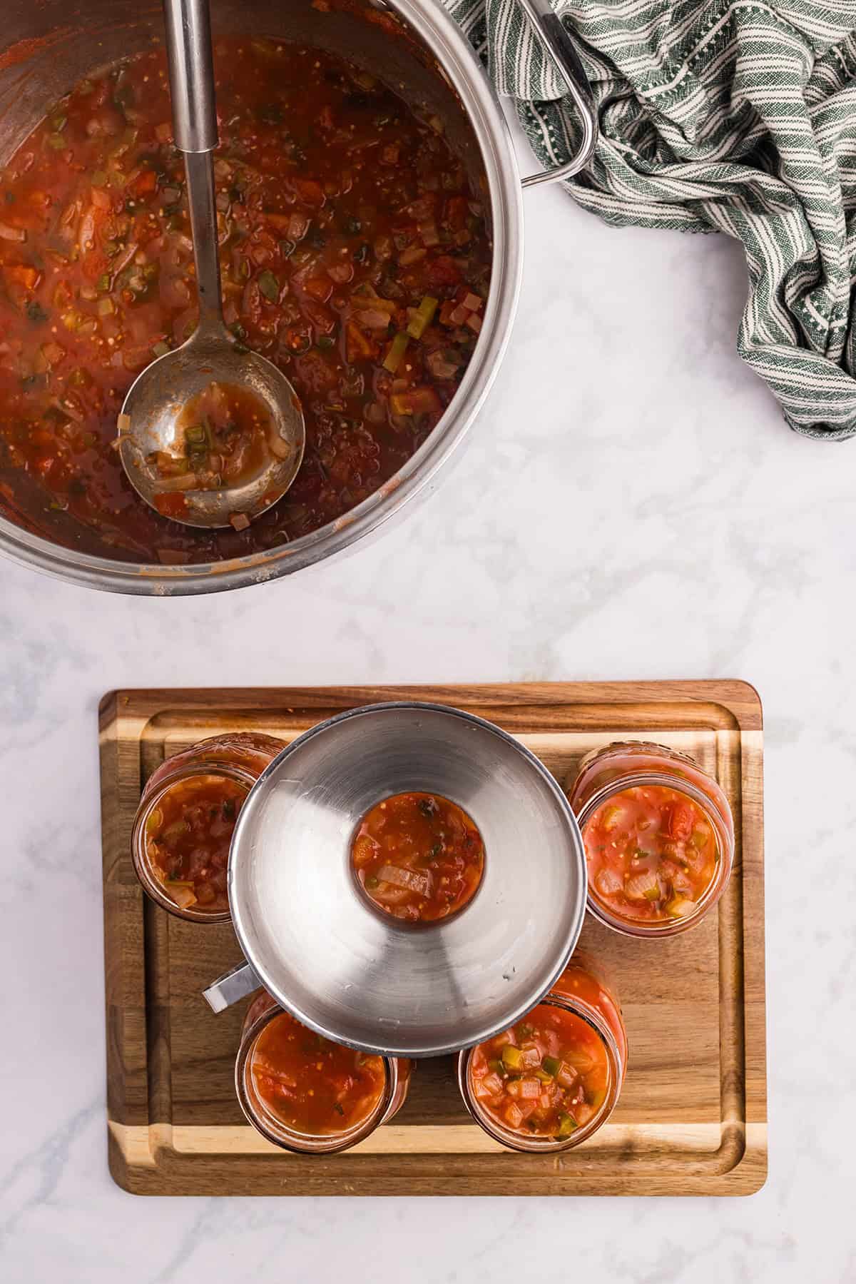 Filling jars with salsa.