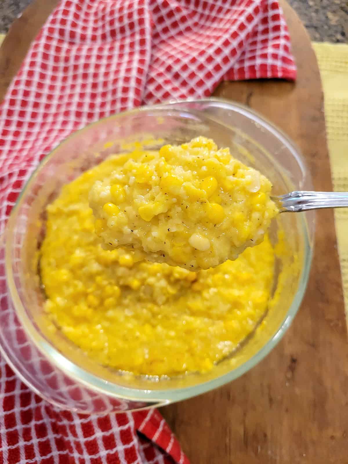 Creamed corn in a glass bowl.