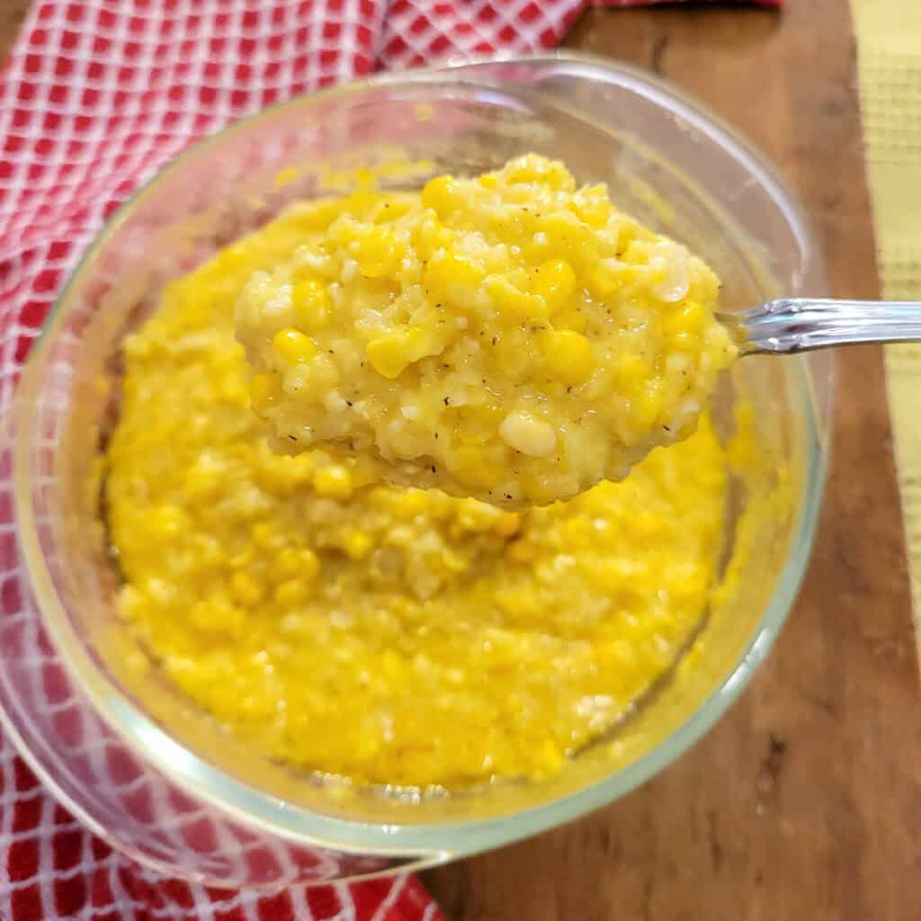 Creamed corn in a glass bowl.