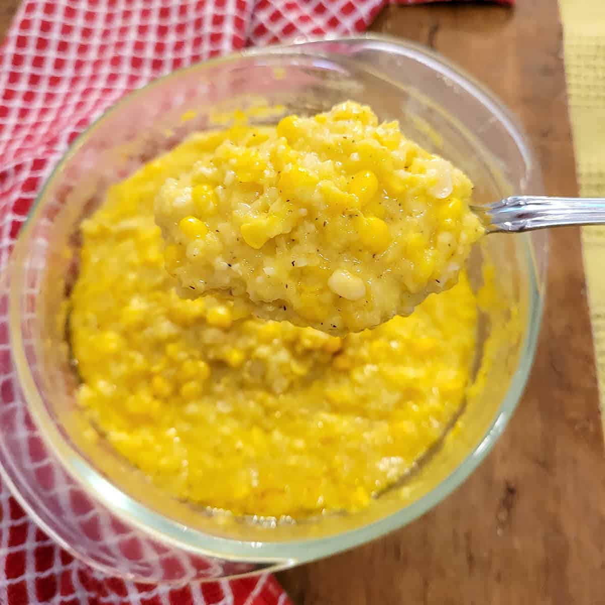 Creamed corn in a glass bowl.