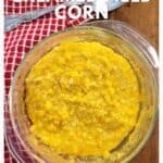 A bowl of creamed field corn sits on a red towel with a spoon beside it. Text reads Creamed Field Corn.