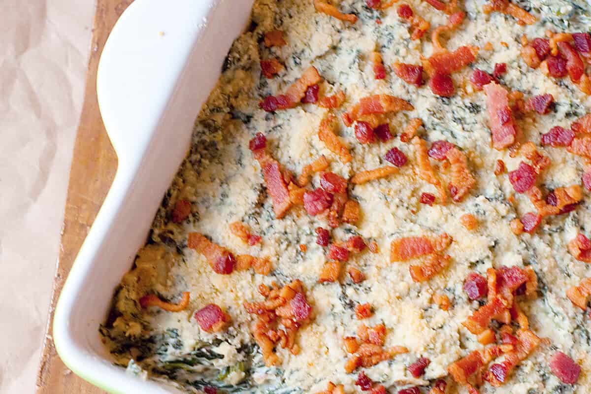 A baking dish filled with turnip green dip.