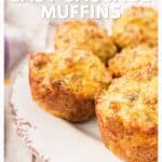 Four golden sausage muffins on a rustic white plate, with text promoting easy sausage muffin recipe.