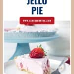 A slice of strawberry jello pie with a fresh strawberry on top, served on a white plate with a fork.