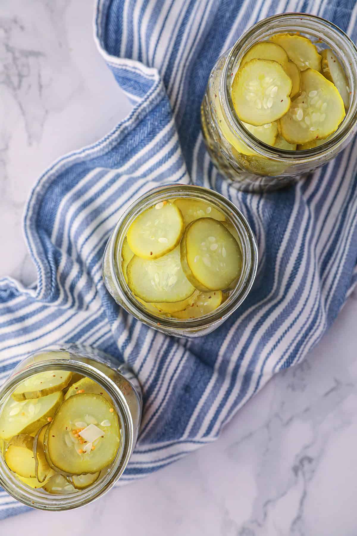 Jars filled with cucumbers and onions.