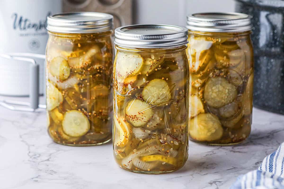 Three pint jars of finished bread and butter pickles.
