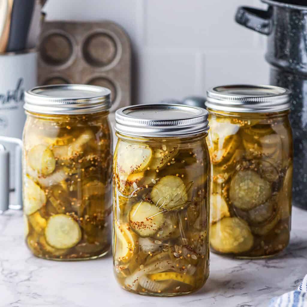 Three pint jars of finished bread and butter pickles.