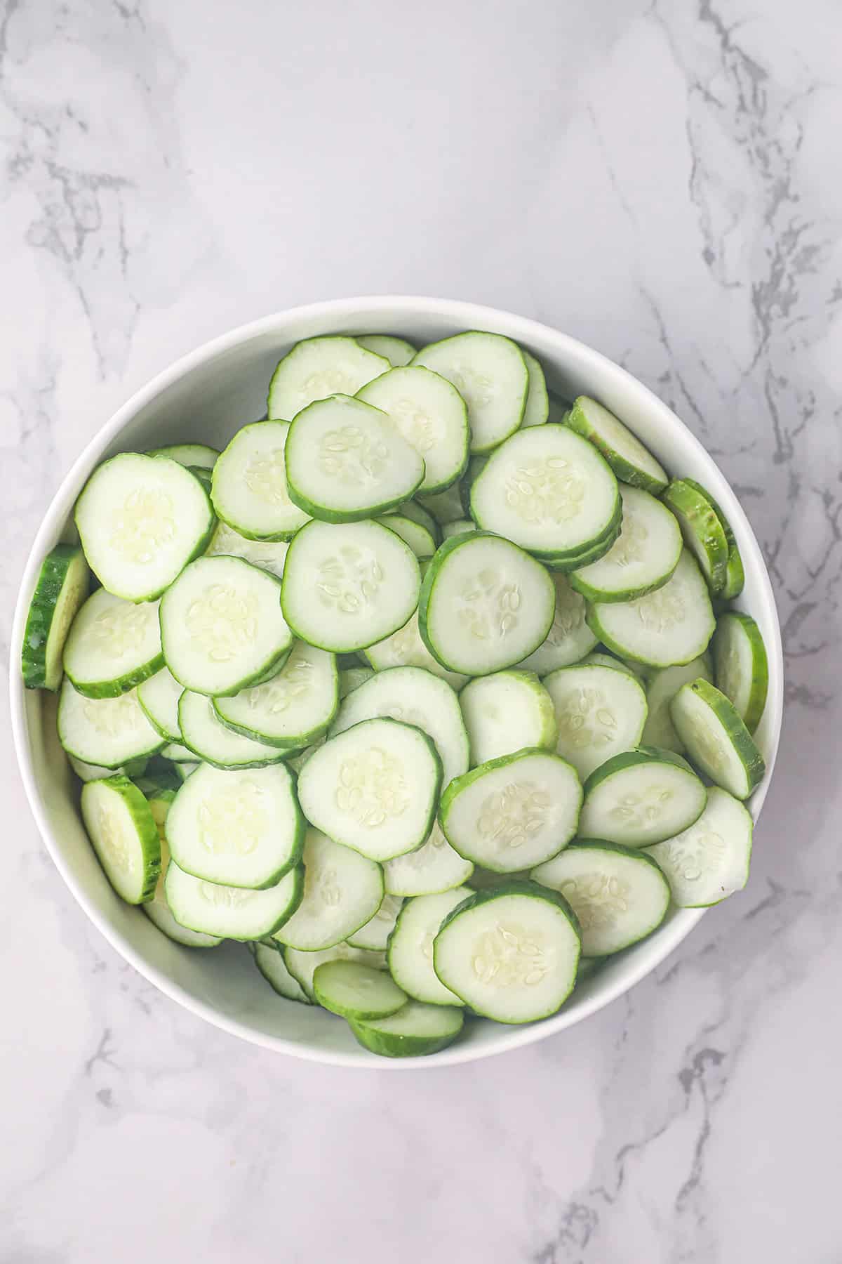 Sliced cucumbers in a colander.