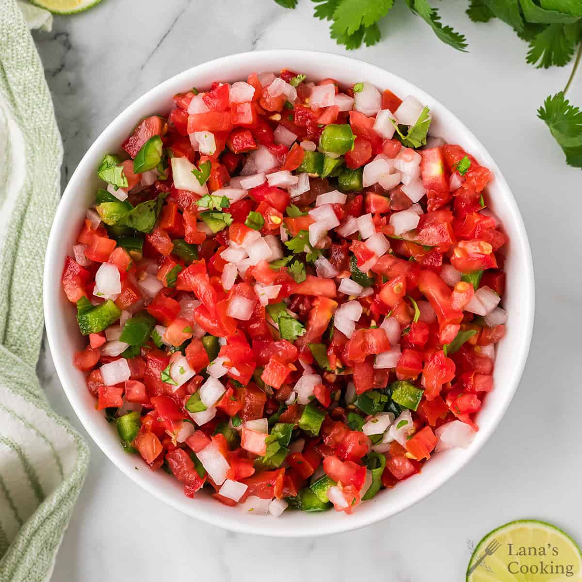 Finished pico de gallo in a white serving bowl.