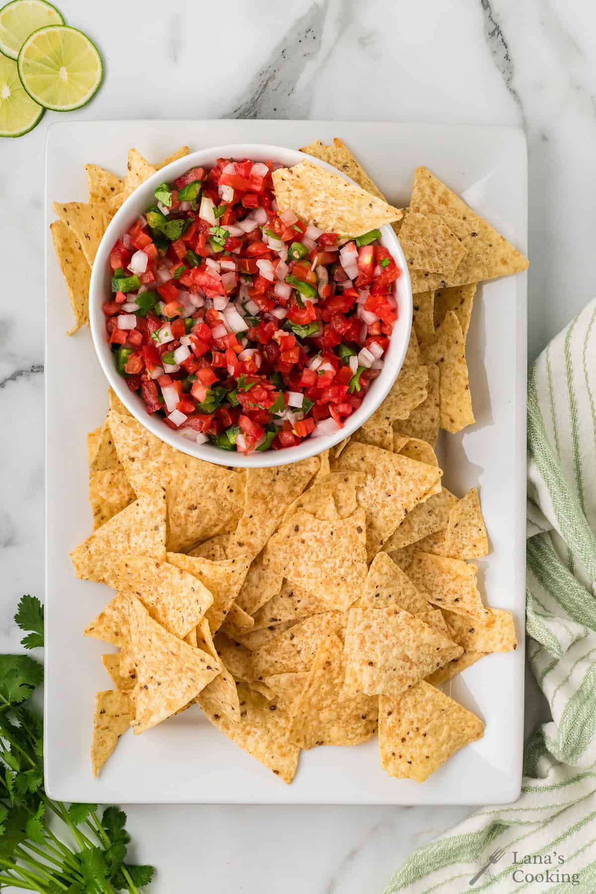Finished pico de gallo in a white serving bowl.