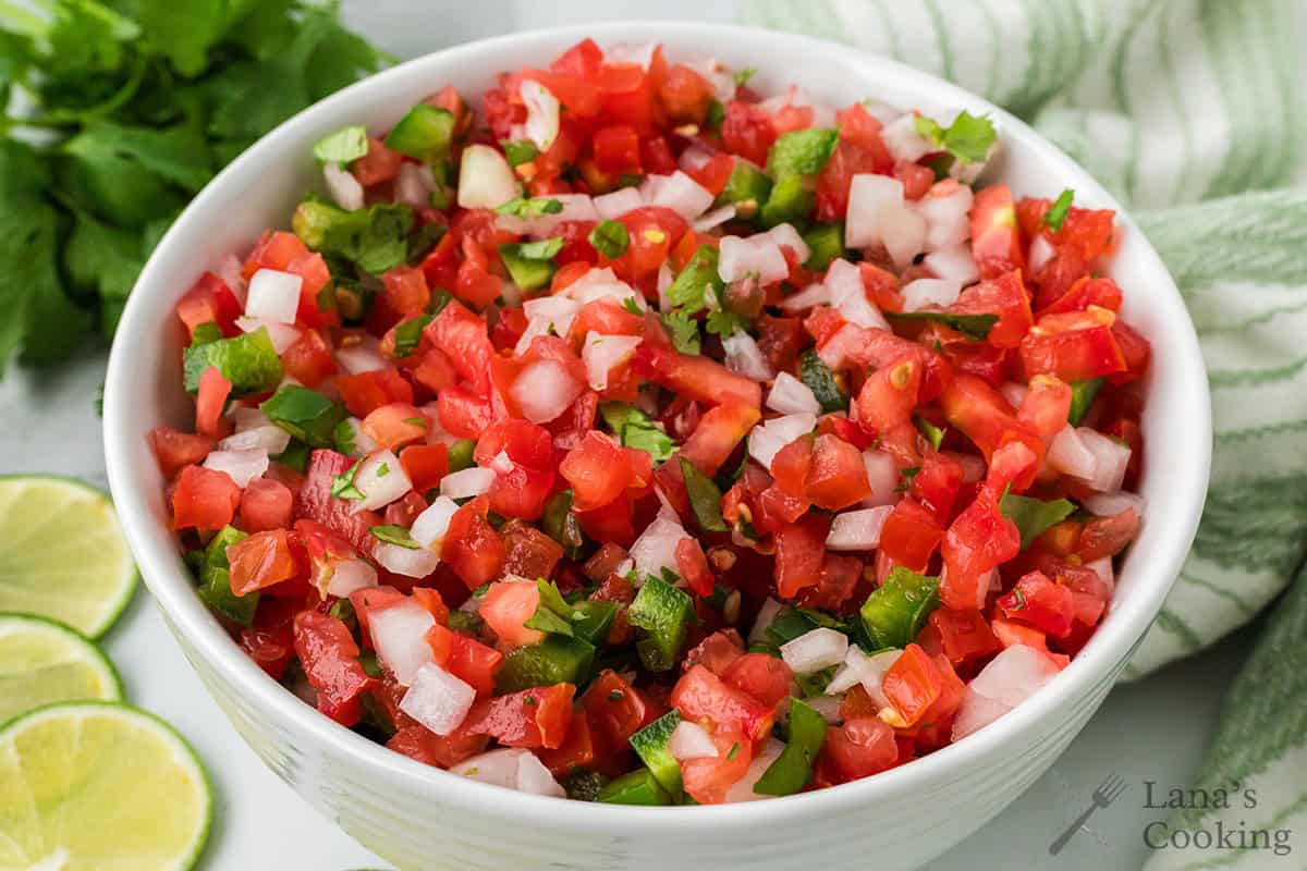 Finished pico de gallo in a white serving bowl.