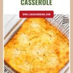 Golden squash and cornbread casserole in a glass baking dish, viewed from above.