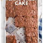 A chocolate sheet cake with a spatula and several pieces cut, on a baking pan next to a blue checkered napkin.