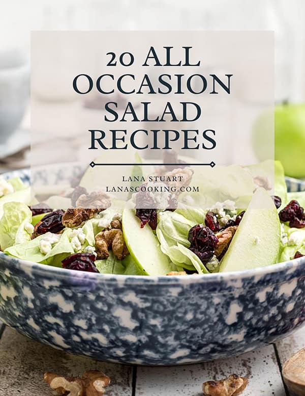 A salad with lettuce, apple slices, cranberries, walnuts, and cheese is in a blue and white bowl. Overlaid text reads, 20 All Occasion Salad Recipes, Lana Stuart, lanascooking.com.