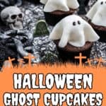 Chocolate cupcakes decorated with white fondant ghosts are displayed on a table with Halloween-themed props, including plastic skulls, gravestones, and fake spiderwebs. Text reads: Halloween Ghost Cupcakes Easy to Make!.