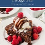 A slice of hot fudge pie topped with vanilla ice cream, chocolate sauce, and fresh raspberries.