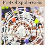 White chocolate spiderweb on pretzel sticks, decorated with candy eyes and colorful candy balls for Halloween.