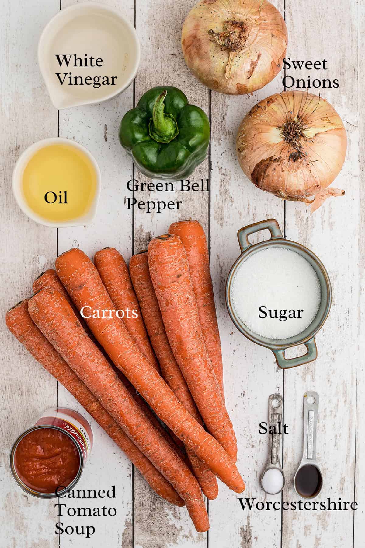 Carrots, onions, green bell pepper, oil, vinegar, sugar, salt, Worcestershire, and tomato soup on a table.