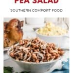 A bowl of black eyed pea salad with onions, next to roast chicken and a plate of potato salad.