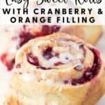 Close-up of cranberry orange sweet rolls topped with icing on a white plate, text overlay describing the recipe.