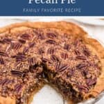 Pecan pie in a glass pie dish with one slice removed.