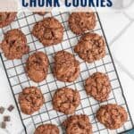 A cooling rack with double chocolate chunk cookies, with text overlay: Double Chocolate Chunk Cookies.