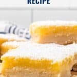 Close-up of lemon bars topped with powdered sugar on a wooden board; text reads Lemon Bars Recipe.