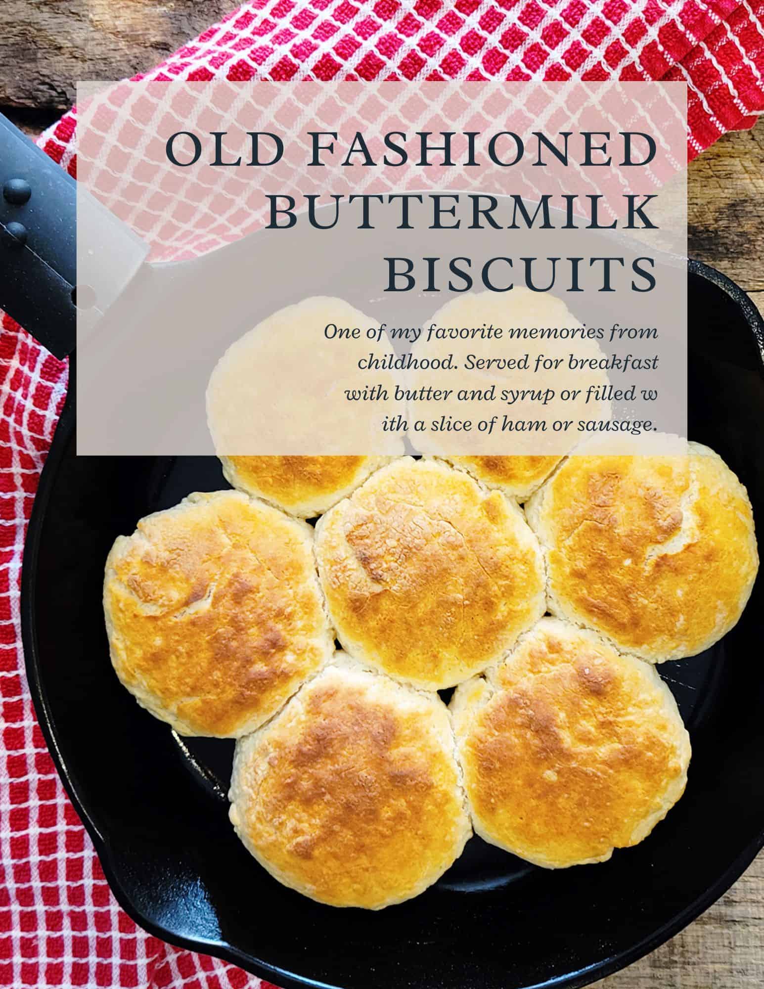 A skillet of seven golden brown buttermilk biscuits sits on a red checkered towel. Text overlay reads Old Fashioned Buttermilk Biscuits with a note about serving them for breakfast with butter, syrup, ham, or sausage.