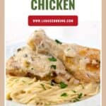 Plate of baked parmesan chicken with creamy sauce served over spaghetti, garnished with chopped parsley.