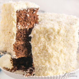 Finished chocolate coconut cake cut so that the interior is showing.