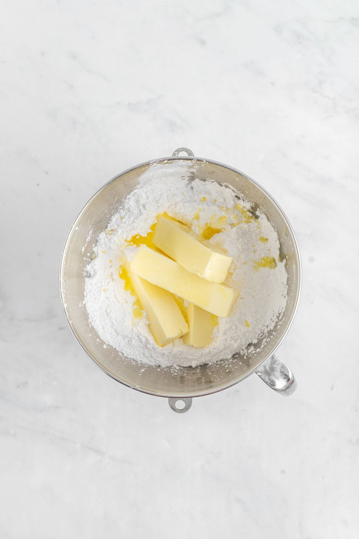 Coconut frosting ingredients in a stand mixer bowl.
