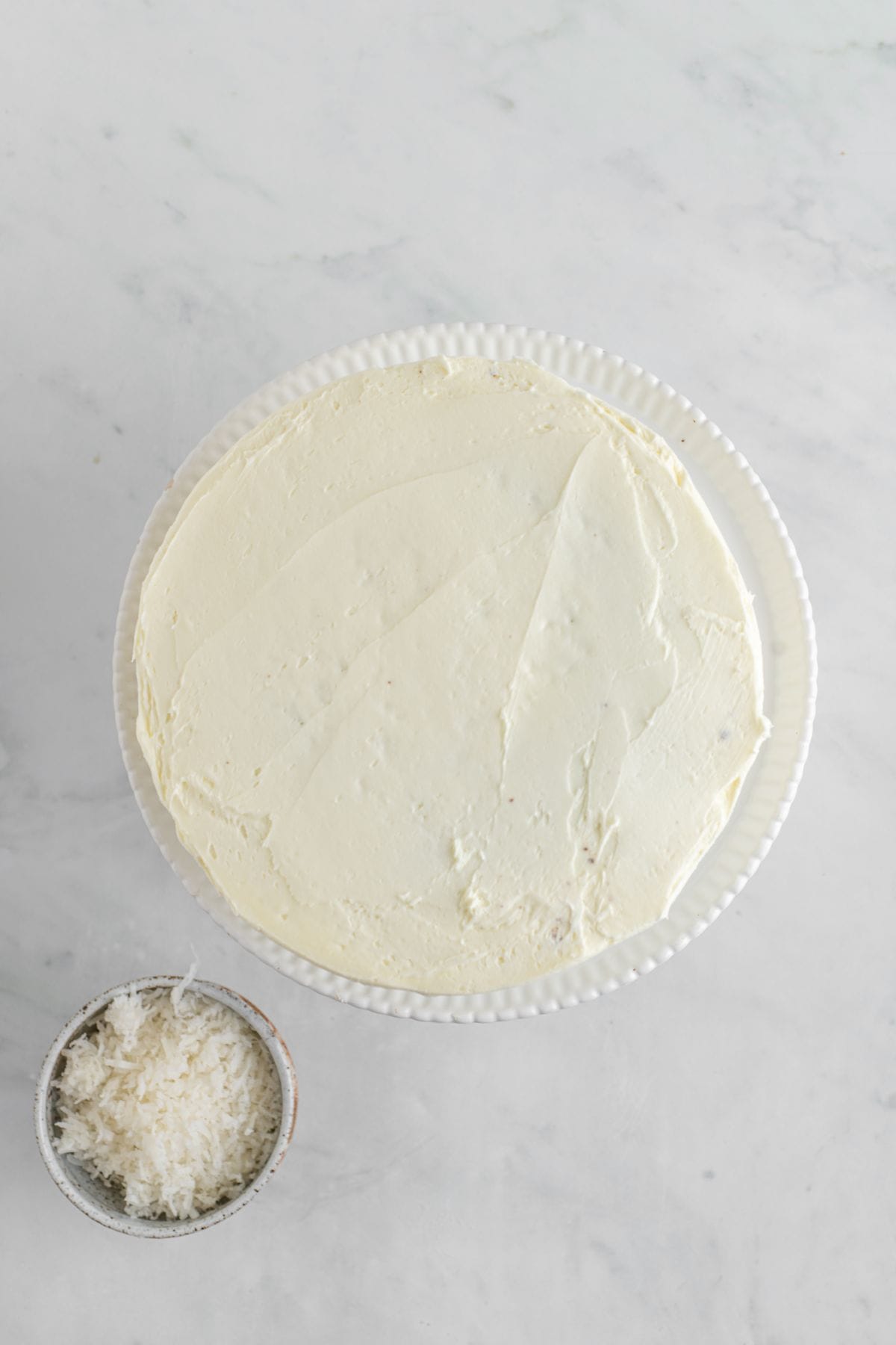 Coconut frosting applied to the outside of the cake.