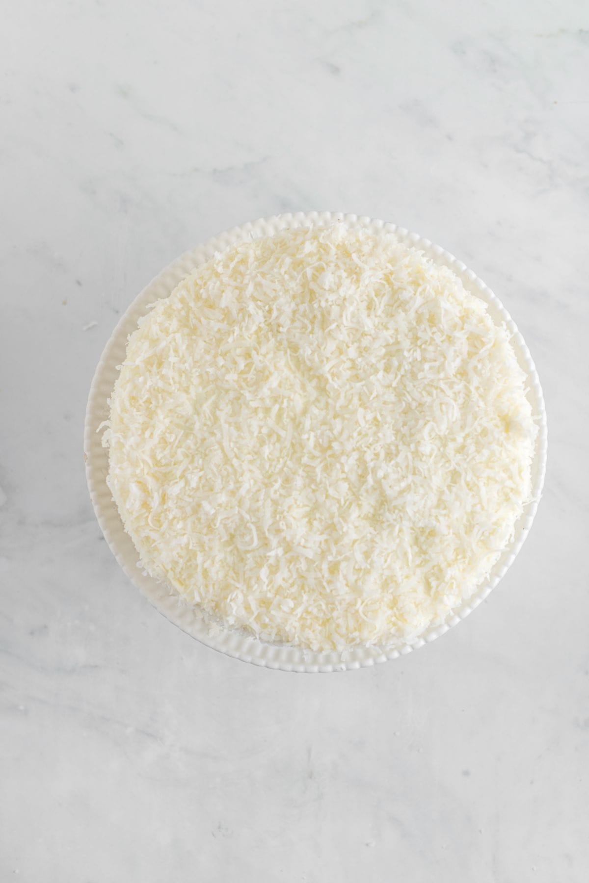 Coconut added to the top and sides of the cake.