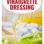 A cruet pours vinaigrette onto lettuce with text: Classic Vinaigrette Dressing, www.lanascooking.com.