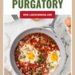 A skillet of eggs in tomato sauce garnished with herbs, labeled Eggs in Purgatory and lanascooking.com.