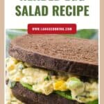 Egg salad sandwich with dark rye bread, lettuce, and herb filling, featured for a herbed egg salad recipe.