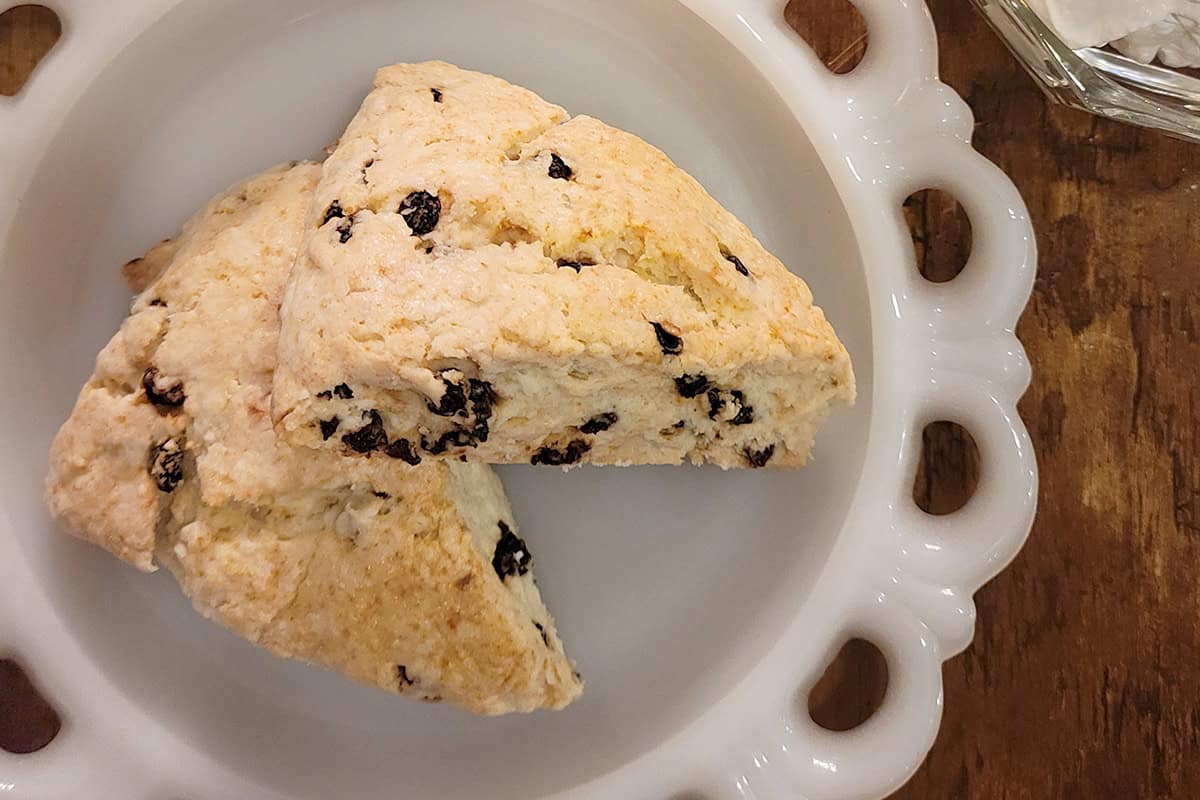Two currant scones on a decorative plate.