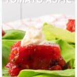 Tomato aspic topped with a dollop of mayonnaise, served on fresh lettuce leaves.