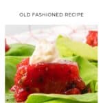 Tomato aspic on lettuce topped with a dollop of mayonnaise, shown with text Old Fashioned Recipe.