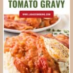 Biscuits topped with tomato gravy and a fried egg, served on a white plate with a garnish.