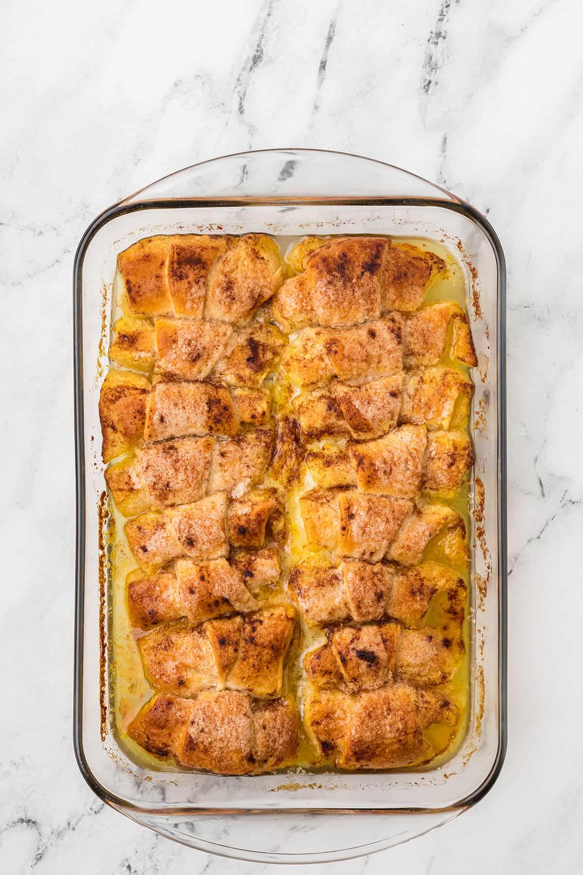 Apple dumplings in the baking dish after cooking.