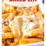 Close-up of cheesy baked ziti in a dish with text overlay Baked Ziti and website www.lanascooking.com.