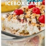 A banana split icebox cake topped with whipped cream, cherries, nuts, and chocolate in a glass dish.