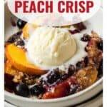 A bowl of blueberry peach crisp topped with vanilla ice cream, with text reading Blueberry Peach Crisp.