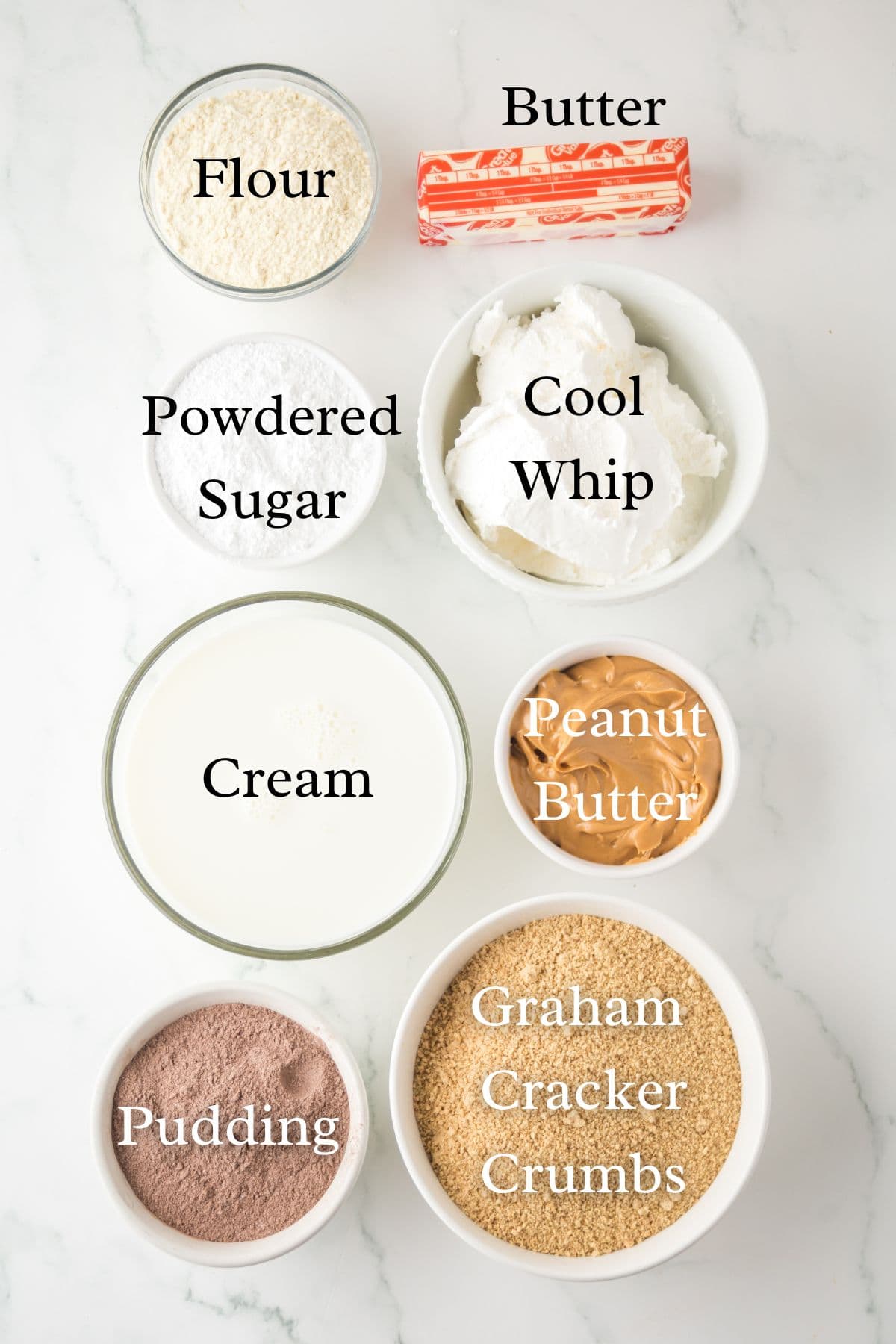 Ingredients for peanut butter delight on a marble background in separate containers.