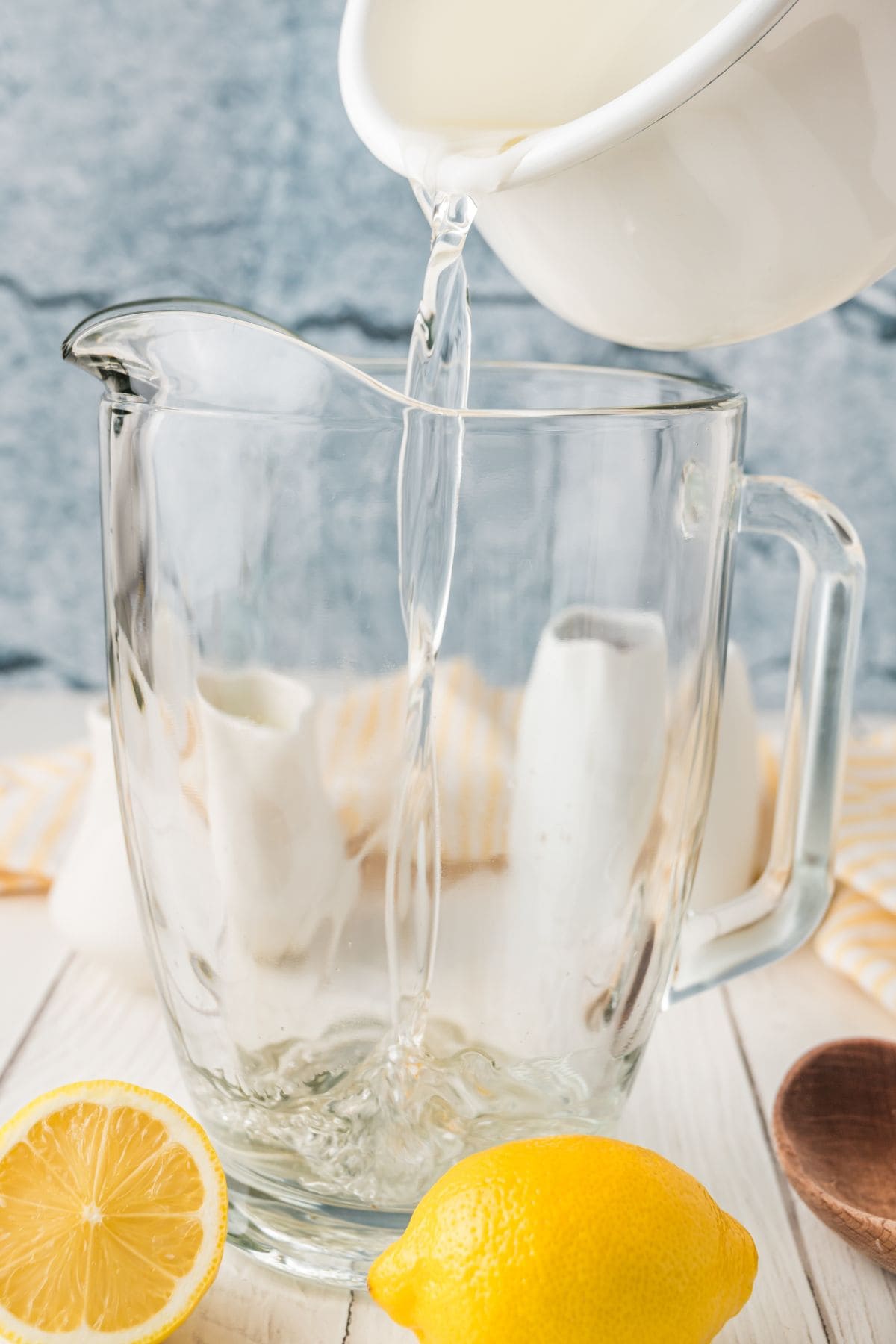 Pouring cooled simple syrup into a pitcher.