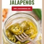 Open jar of pickled jalapeños with a fork inside, seen from above, and recipe website text at the top.