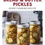 Three jars of homemade sugar-free bread and butter pickles sit on a kitchen counter with a white background.